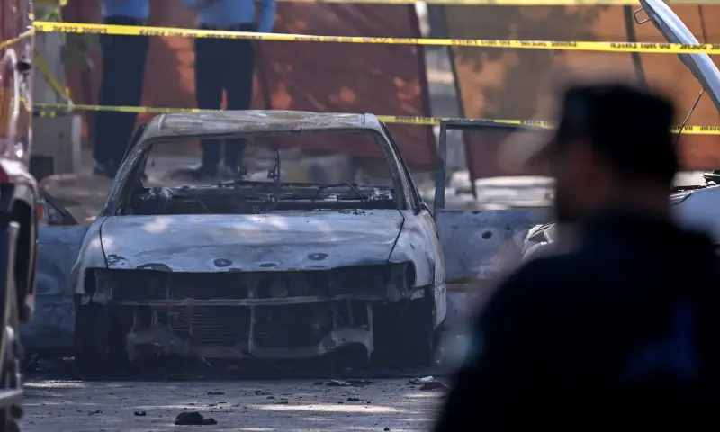 A charred car is pictured at the suicide blast site in Islamabad. &mdash; AFP