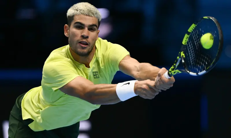 Spain&rsquo;s Carlos Alcaraz plays a backhand return to USA&rsquo;s Taylor Fritz during the ATP Finals tennis tournament in Turin on November 11, 2025. &mdash; AFP