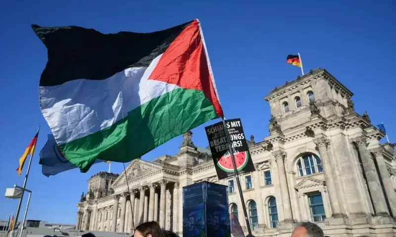 Participants march with a Palestinian flag during a demonstration under the motto ‘Draw the red line with us: Together for Gaza!’ in front of the Reichstag building, housing the lower house of German parliament Bundestag, in the center of Berlin on September 27. — AFP Participants march with a Palestinian flag during a demonstration under the motto ‘Draw the red line with us: Together for Gaza!’ in front of the Reichstag building, housing the lower house of German parliament Bundestag, in the center of Berlin on September 27. — AFP
