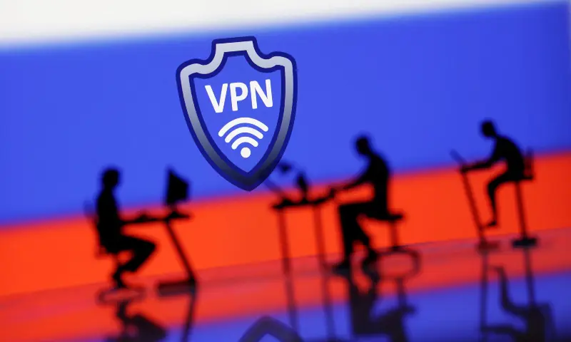 A VPN sign is seen in front of silhouetted miniatures of people with computers and the Russian flag in this illustration taken on April 23, 2024. &mdash; Reuters/Illustration/File