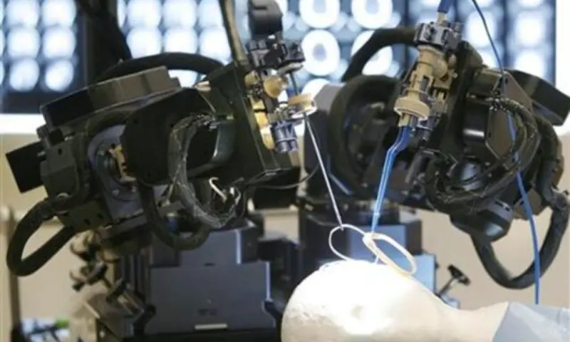 A neurosurgery robot arm is demonstrated in Calgary, Alberta, on April 17, 2007. &mdash; Reuters/File