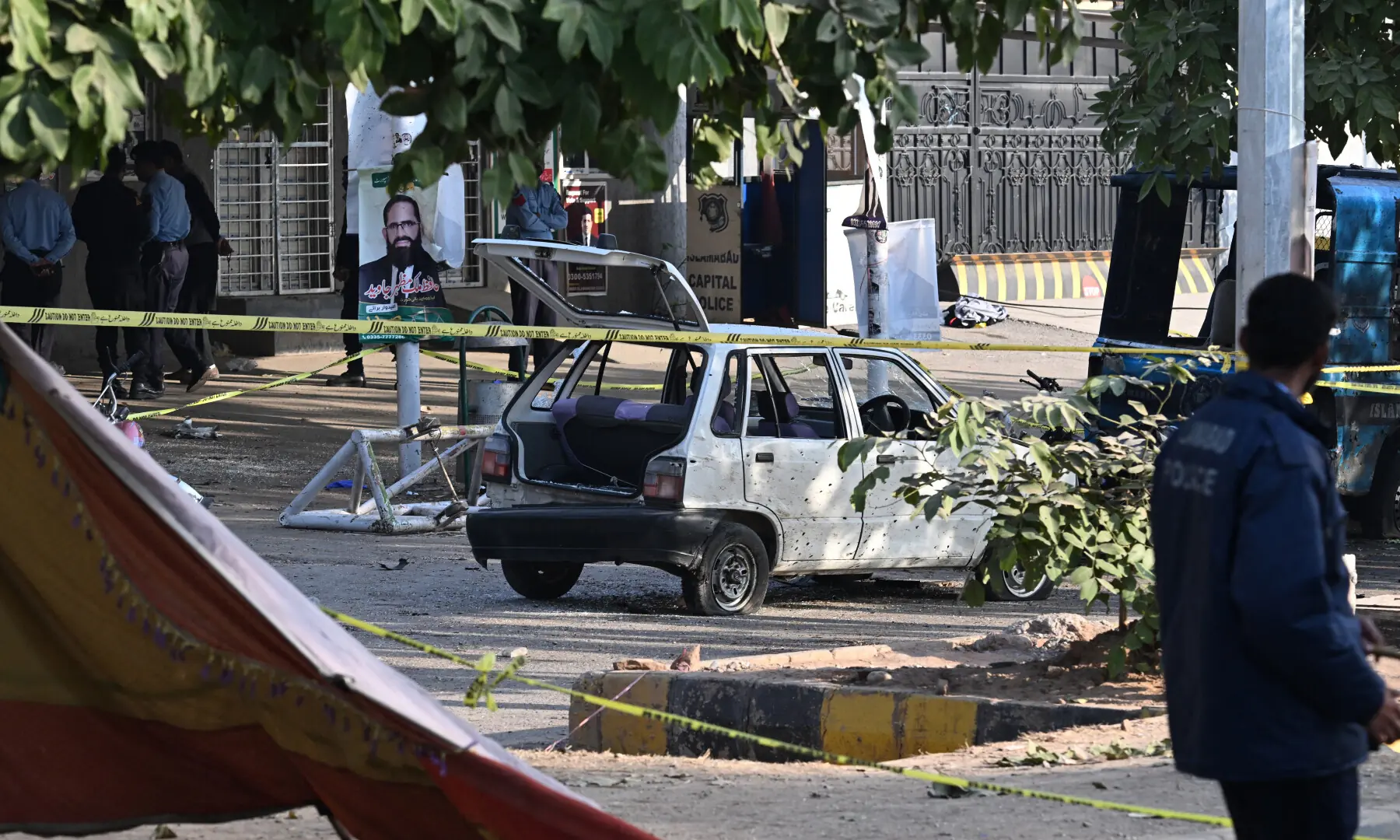 Police officials inspect the cordoned-off site, a day after the suicide bombing, in Islamabad on Nov 12, 2025. — AFP Police officials inspect the cordoned-off site, a day after the suicide bombing, in Islamabad on Nov 12, 2025. — AFP