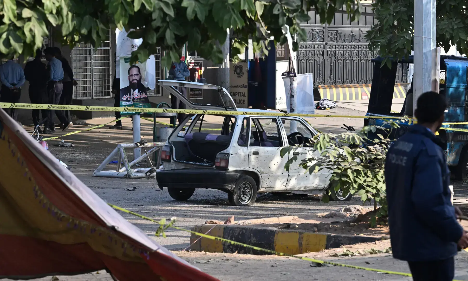Police officials inspect the cordoned-off site, a day after the suicide bombing, in Islamabad on Nov 12, 2025. — AFP Police officials inspect the cordoned-off site, a day after the suicide bombing, in Islamabad on Nov 12, 2025. — AFP