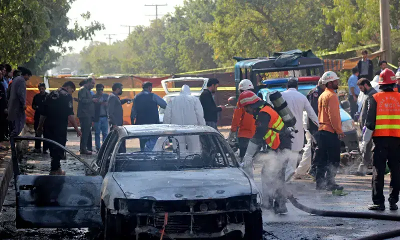Firefighters douse a car at the suicide blast site in Islamabad on November 11. &mdash; AFP