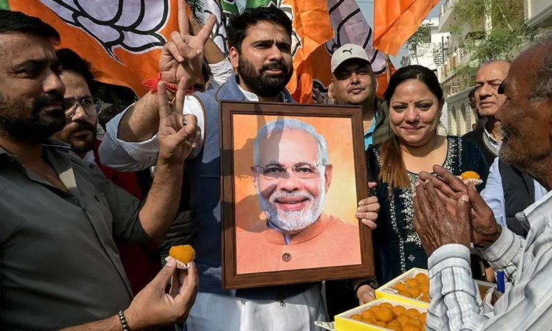 Supporters of the Bharatiya Janata Party hold a photograph of India’s Prime Minister Narendra Modi as they celebrate vote counting results of the party’s victory in the Bihar assembly elections, in Amritsar, India on November 14. — AFP Supporters of the Bharatiya Janata Party hold a photograph of India’s Prime Minister Narendra Modi as they celebrate vote counting results of the party’s victory in the Bihar assembly elections, in Amritsar, India on November 14. — AFP