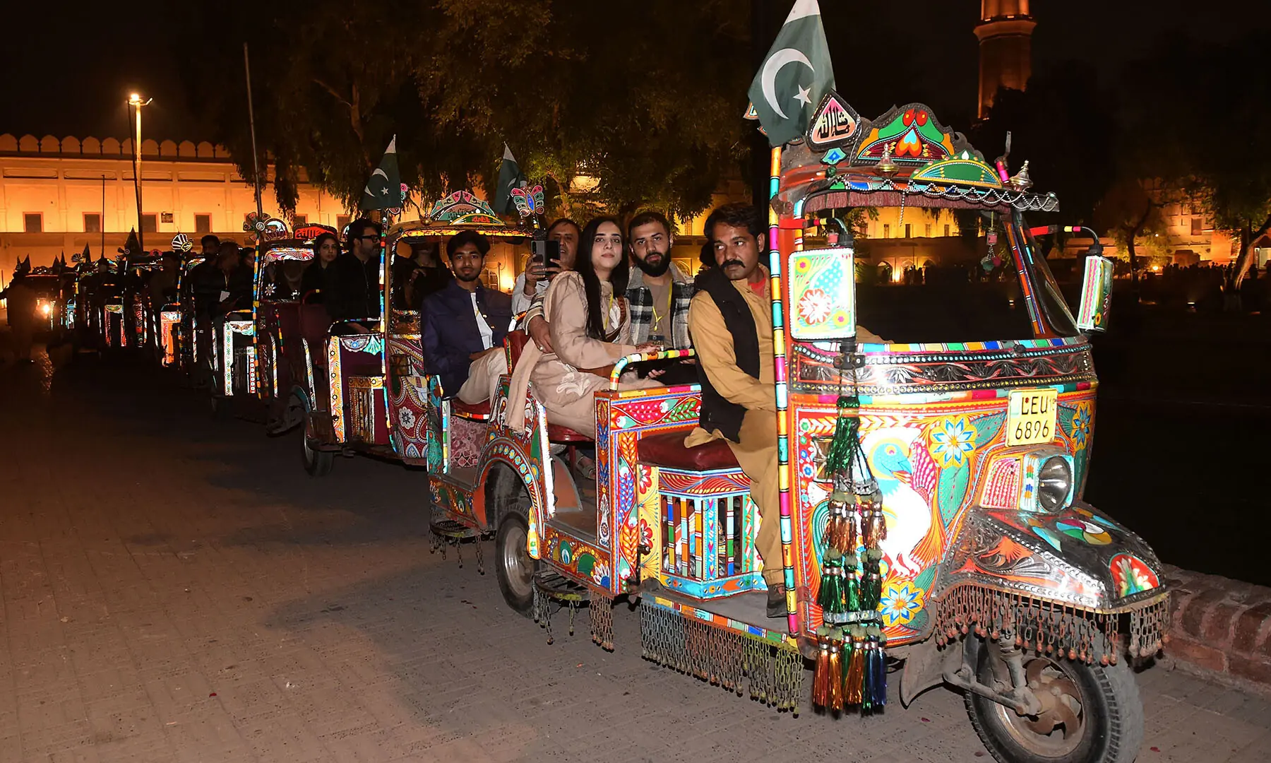 Visitors ride modified rickshaws during a night tour of the walled city of Lahore on November 15. —White Star/Murtaza Ali