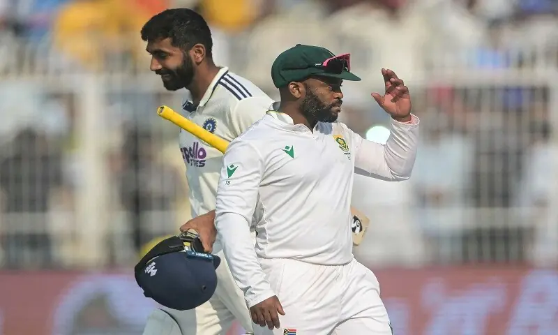 South Africa&rsquo;s captain Temba Bavuma (R) walks past Indian tailender Jasprit Bumrah after his side won the first Test at Eden Gardens in Kolkata on November 16, 2025.&mdash;AFP