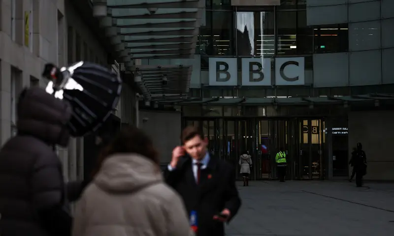 A television crew report from outside the entrance to the offices of British broadcaster BBC in London on November 11, 2025. &mdash; AFP