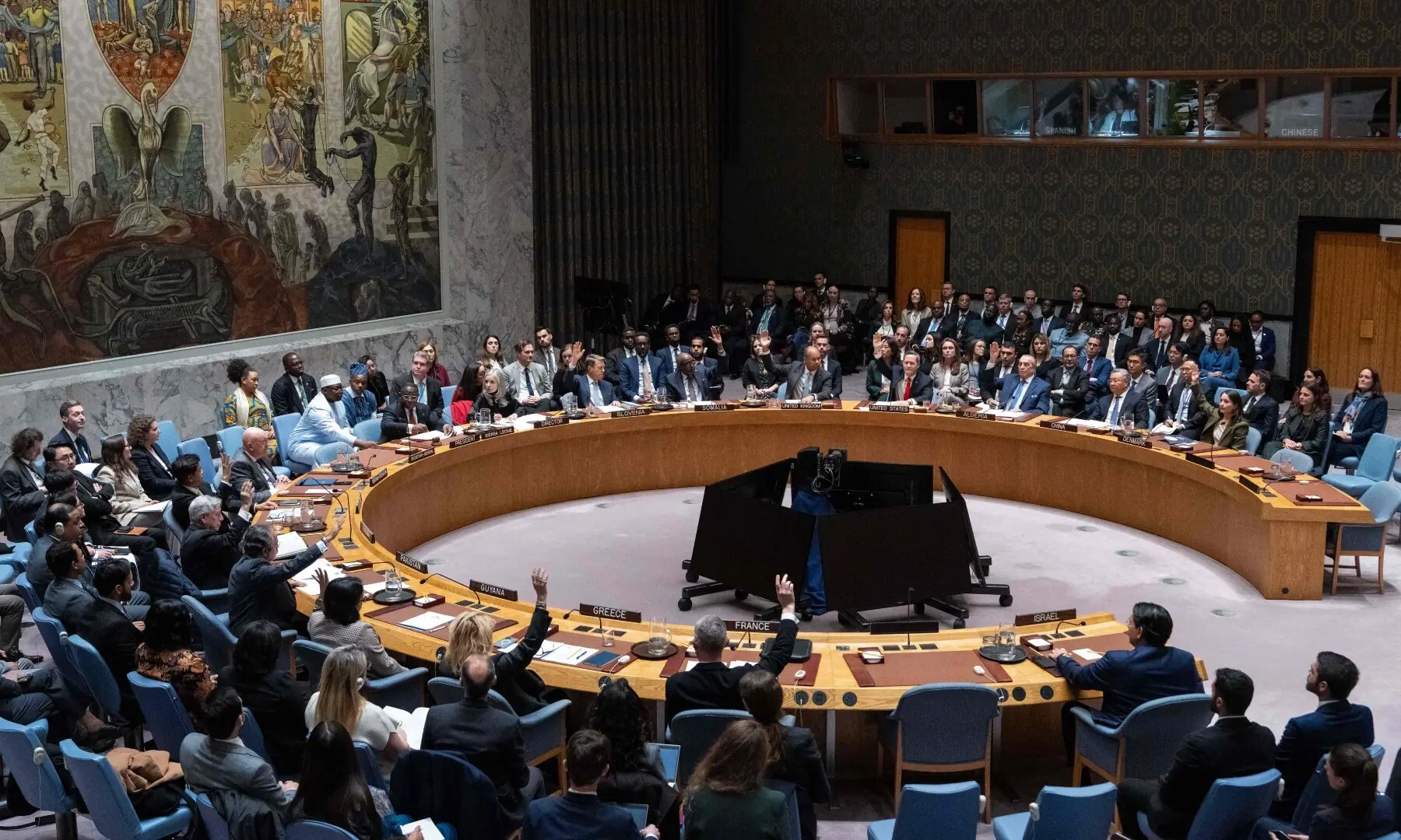 Members of the UN Security Council raise their hands to vote in favor of a draft resolution to authorise an International Stabilisation Force in Gaza, on Nov 17, 2025 at UN headquarters in New York City. — AFP