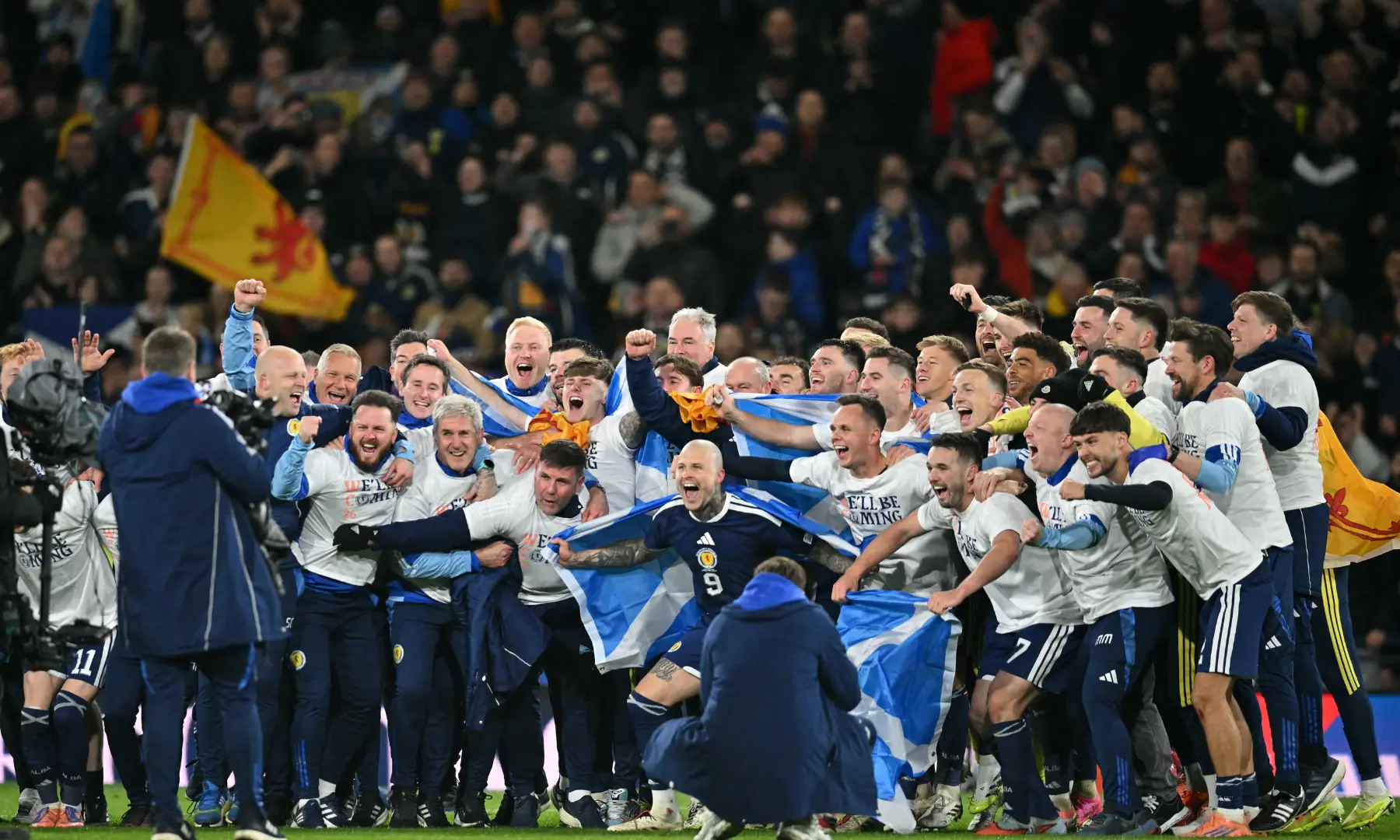 Scotland players celebrate on the pitch after the FIFA World Cup 2026 European qualification football match between Scotland and Denmark at Hampden Park in Glasgow on November 18, 2025. &mdash; AFP