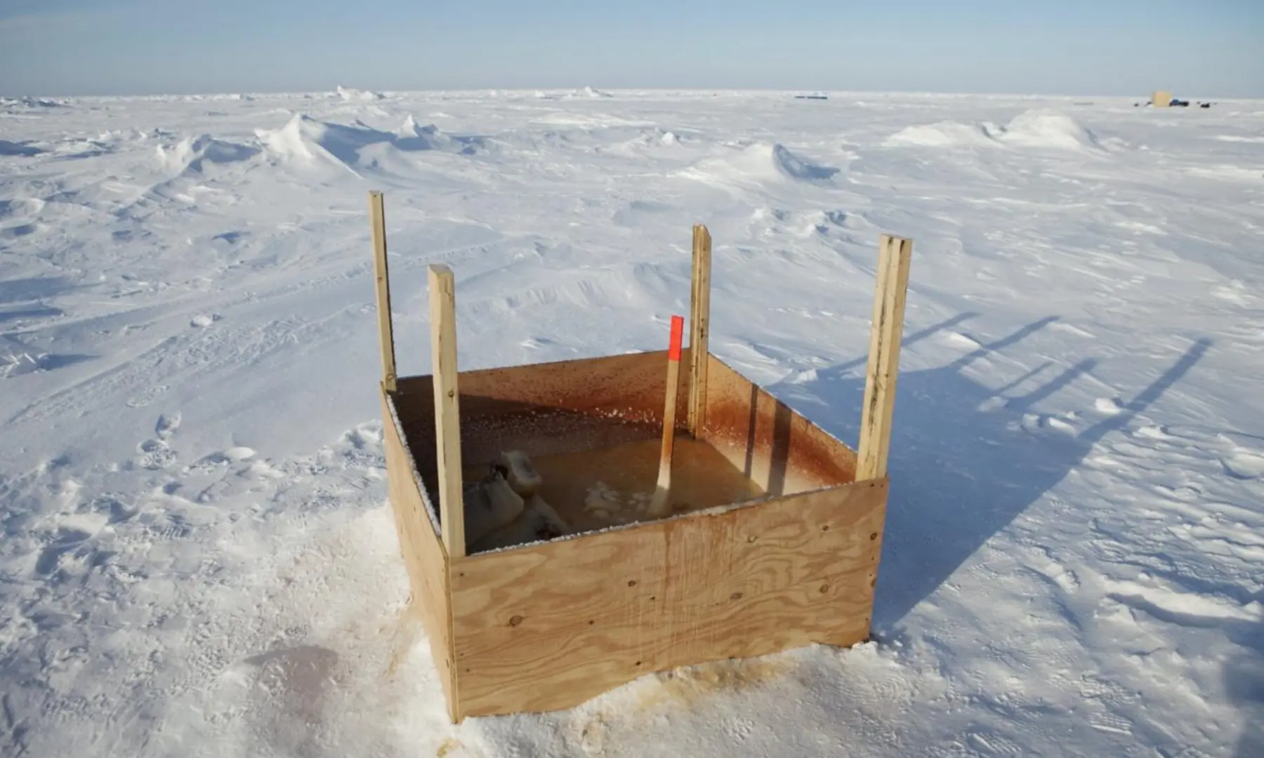 A public toilet stands surrounded by snow near the 2011 Applied Physics Laboratory Ice Station north of Prudhoe Bay, Alaska, on March 18, 2011. — Reuters