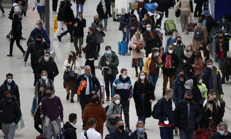 People wearing protective face masks walk through Waterloo train station on January 3, 2023. —Reuters People wearing protective face masks walk through Waterloo train station on January 3, 2023. —Reuters