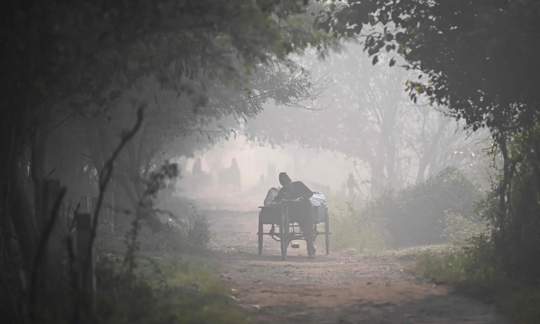 Commuters travel amid smoggy conditions in New Delhi on November 21. &mdash; AFP