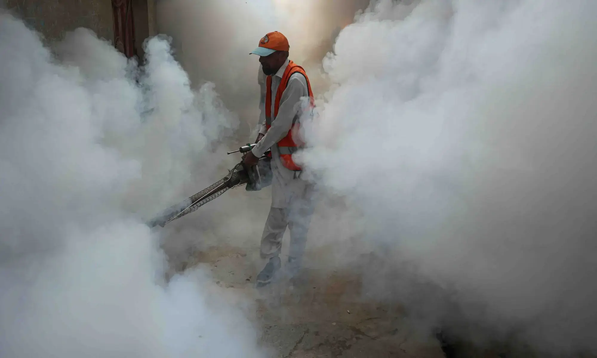 A worker sprays fumigation vapour to stem the spread of dengue virus in Peshawar on October 30, 2025. &mdash; Reuters/File
