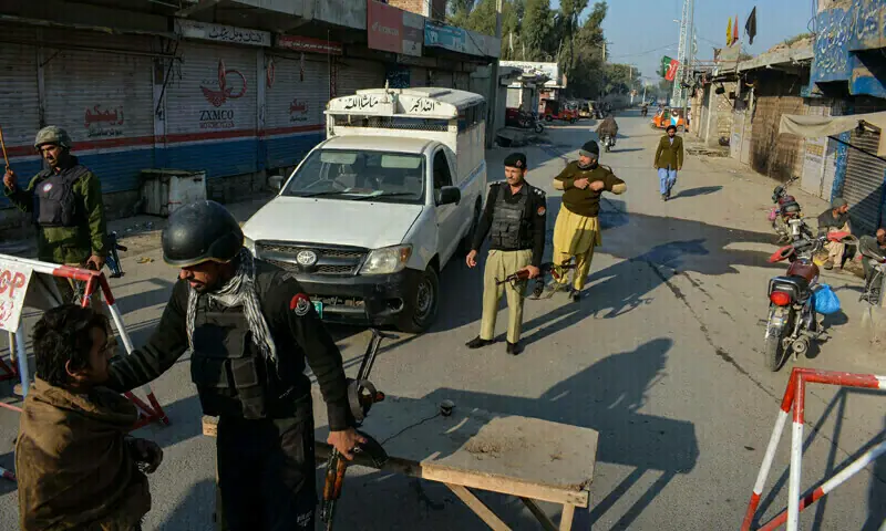 Police stand guard along a road they blocked after militants seized a police station in Bannu on December 19, 2022. &mdash; AFP/File
