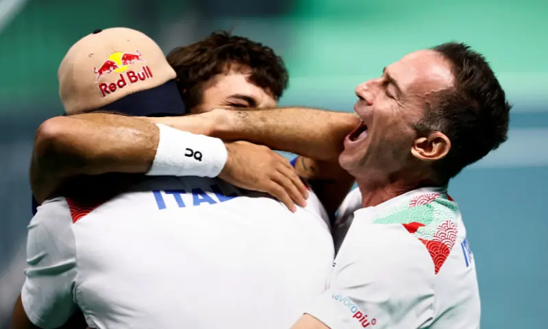 Italy&rsquo;s Flavio Cobolli celebrates with teammates and captain Filippo Volandri after winning his singles match against Belgium&rsquo;s Zizou Bergs at the Davis Cup semi final, Italy v Belgium at the SuperTennis Arena, Bologna, Italy on November 21, 2025. &mdash; Reuters