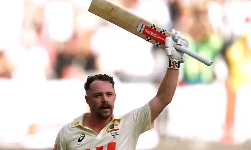 Australia&rsquo;s Travis Head raises his bat as he walks after losing his wicket, caught by England&rsquo;s Ollie Pope off the bowling of Brydon Carse at The Ashes First Test at Perth Stadium, Perth, Australia on November 22, 2025. &mdash; Reuters