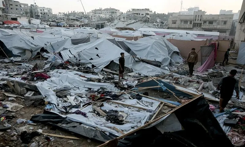Palestinians are seen surveying the area where displaced people had set up their tent homes, following an Israeli military strike in Gaza City, on November 22, 2025. &mdash; AFP