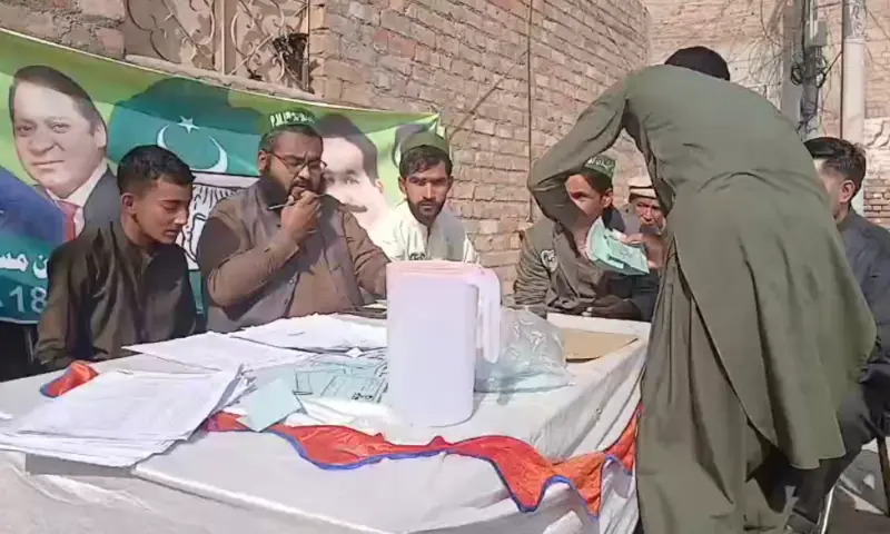 PML-N workers sit at their party camp outside a polling station in Haripur, KP on Nov 23, 2025. — via Muhammad Sadaqat