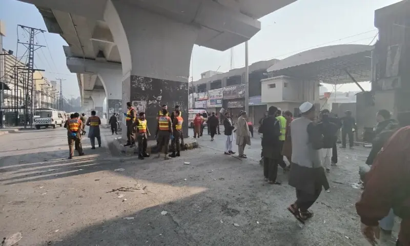 Police and rescue official gather outside the Federal Constabulary (FC) headquarters after it was targeted by terrorists. — Photo courtesy Rescue 1122