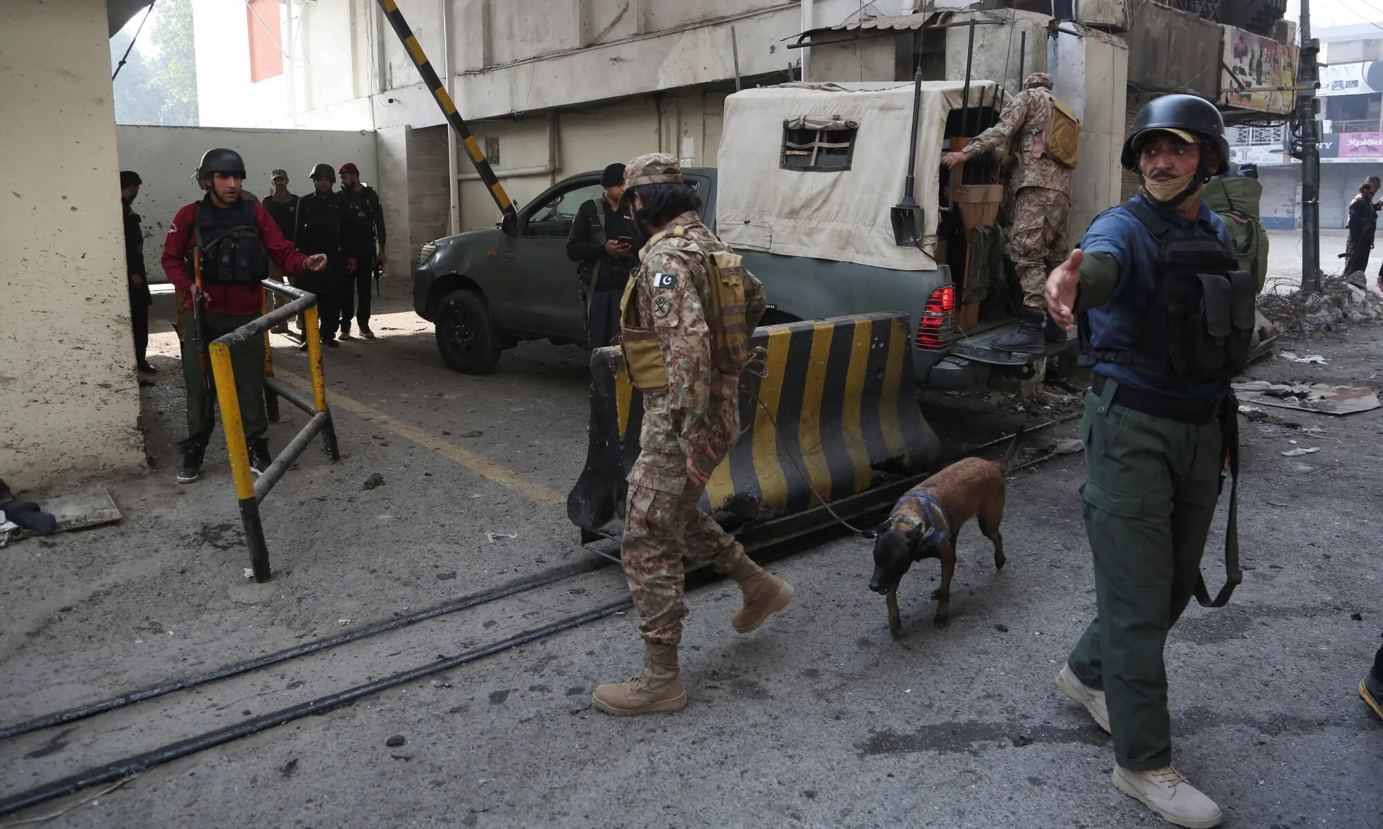 Army soldiers secure the entrance site after suicide bombers targeted the headquarters of a paramilitary force in Peshawar on November 24. &mdash; Reuters