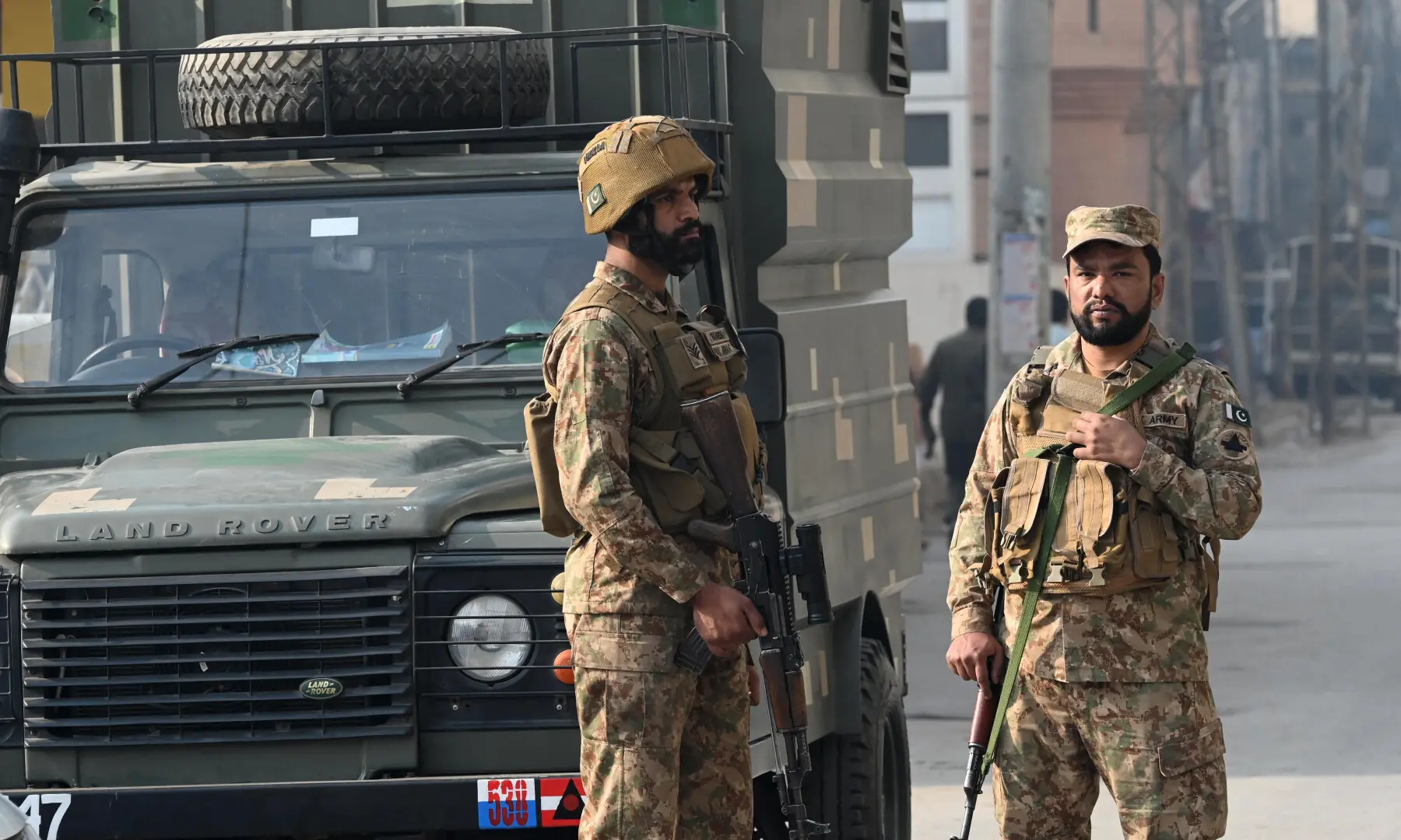 Security personnel stand guard at the site of a suicide attack outside the Federal Constabulary headquarters in Peshawar on November 24. — AFP
