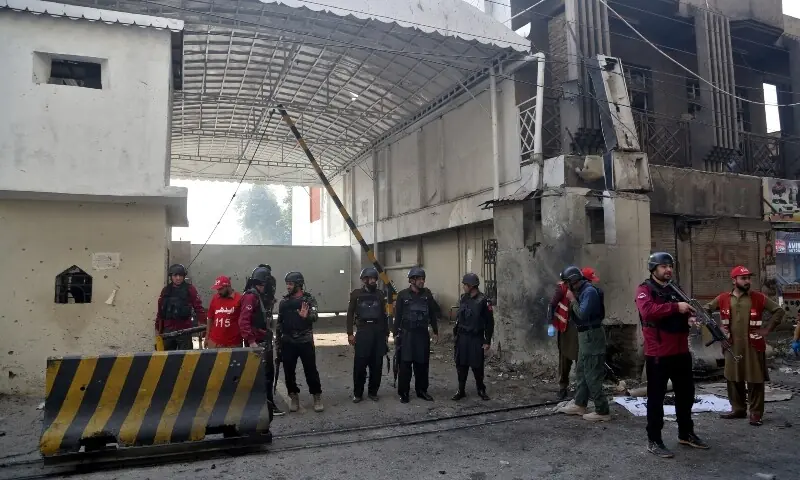 Army soldiers secure the entrance site after suicide bombers targeted the headquarters of a paramilitary force in Peshawar on November 24. &mdash; Reuters