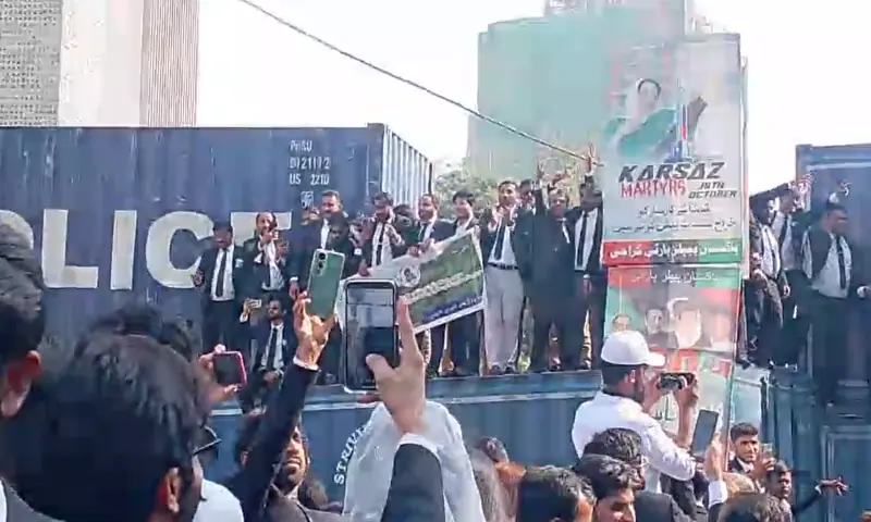 Containers placed on roads and police deployed as lawyers hold a protest march in Karachi on Nov 26. &mdash; Screengrab from video provided by author