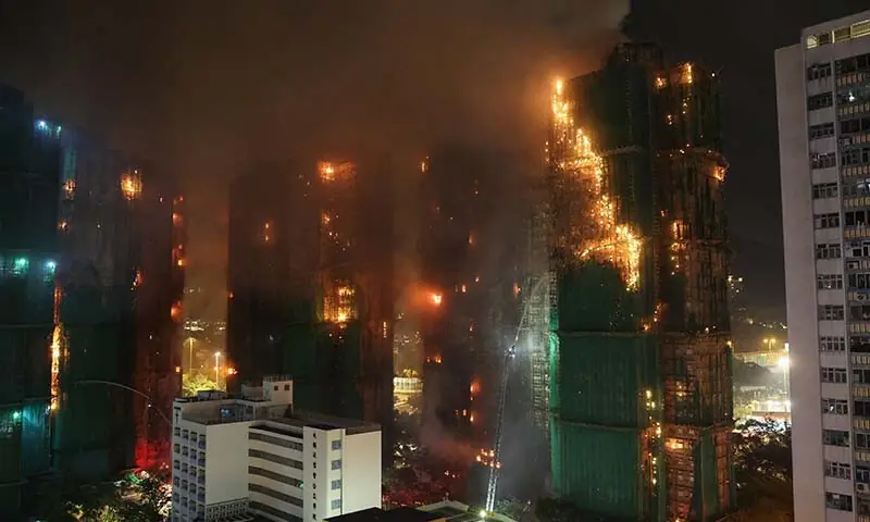 Firefighters work to extinguish flames as bamboo scaffolding burns across multiple buildings at Wang Fuk Court housing estate, in Tai Po, Hong Kong, China, November 26. &mdash; Reuters