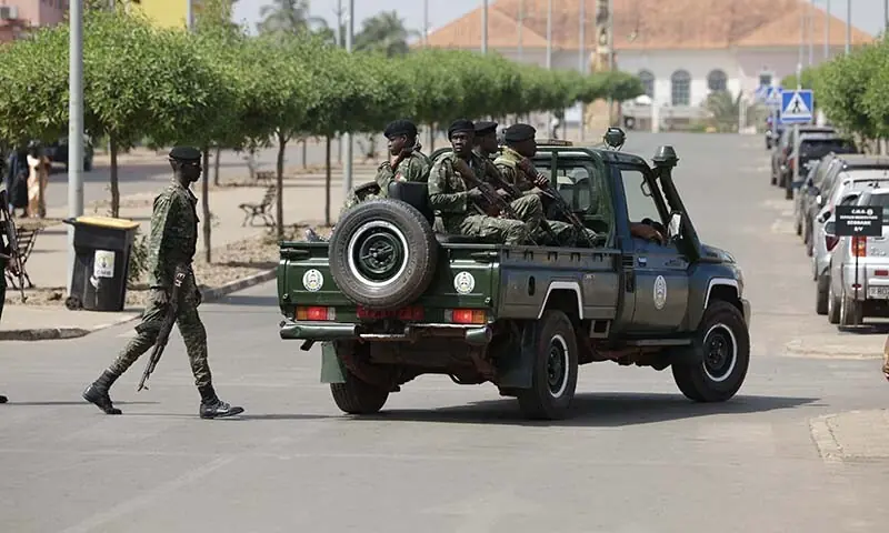 Soldiers hold weapons while patrolling a street near the scene of gunfire near the Presidential Palace in Bissau, guinea-Bissau on November 26. &mdash; AFP