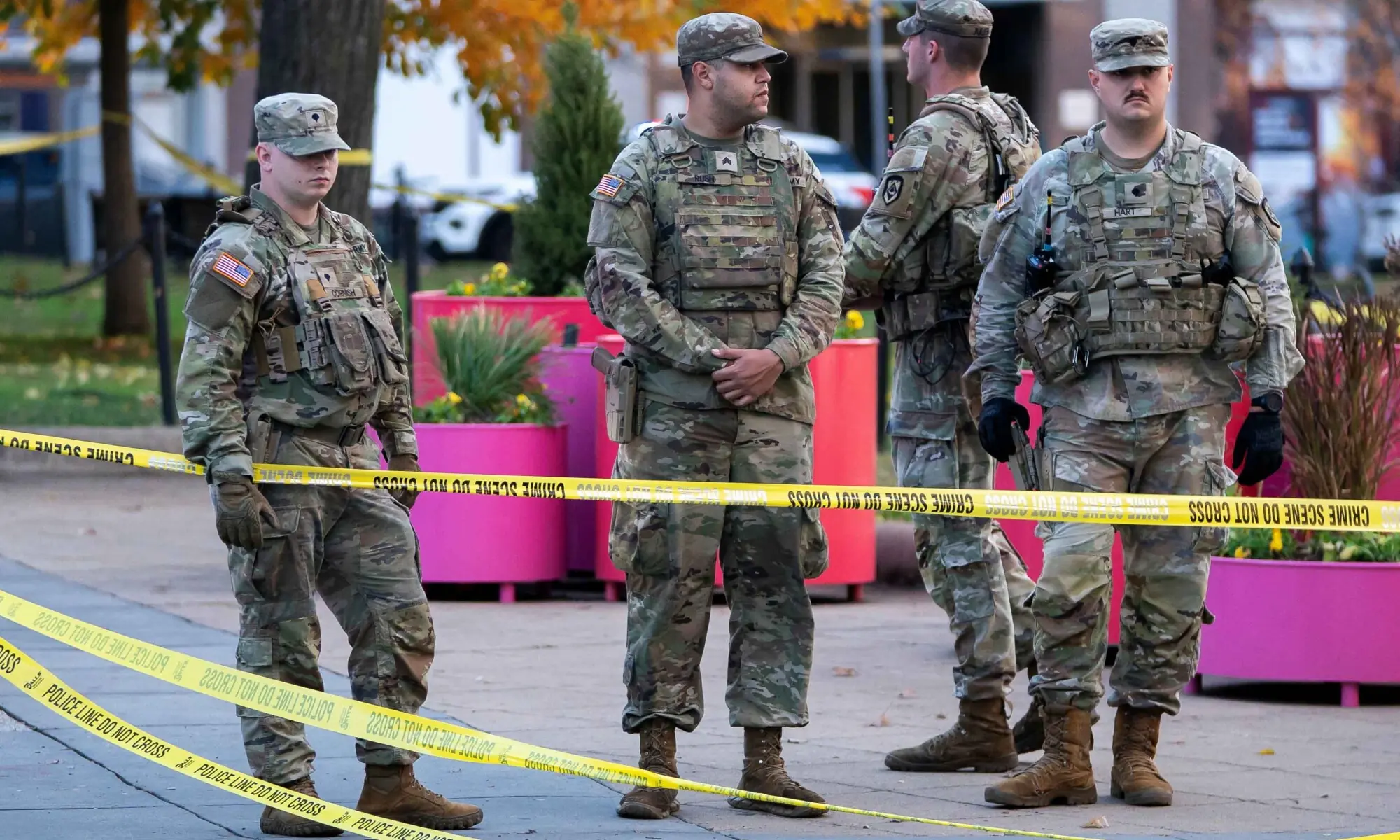 National Guard members stand together behind yellow tape, after two National Guard members were shot near the White House in Washington, DC, US on November 26. &mdash; Reuters