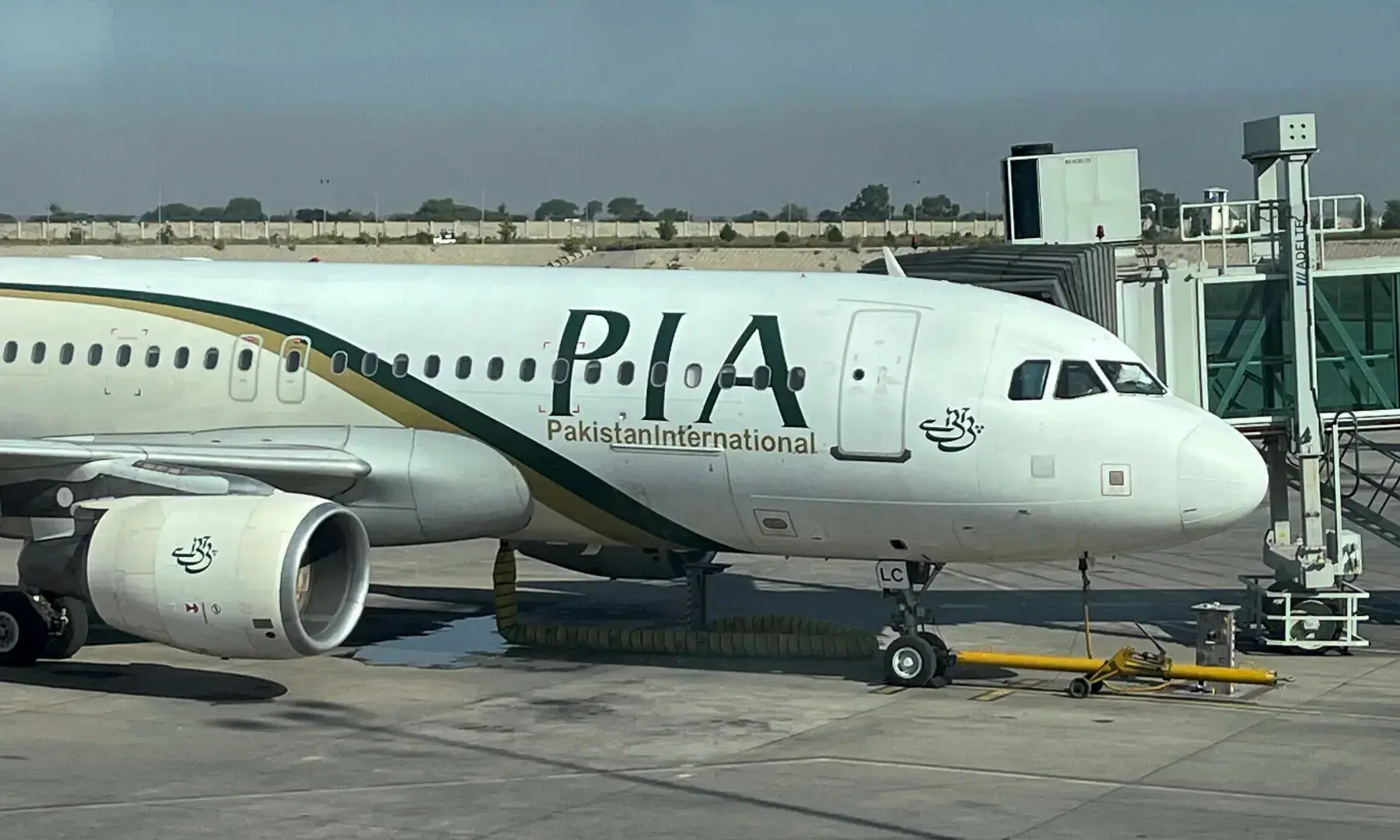 View of a Pakistan International Airlines (PIA) passenger plane, taken through a glass panel, at Islamabad International Airport, on Oct 3, 2023. &mdash; Reuters/File