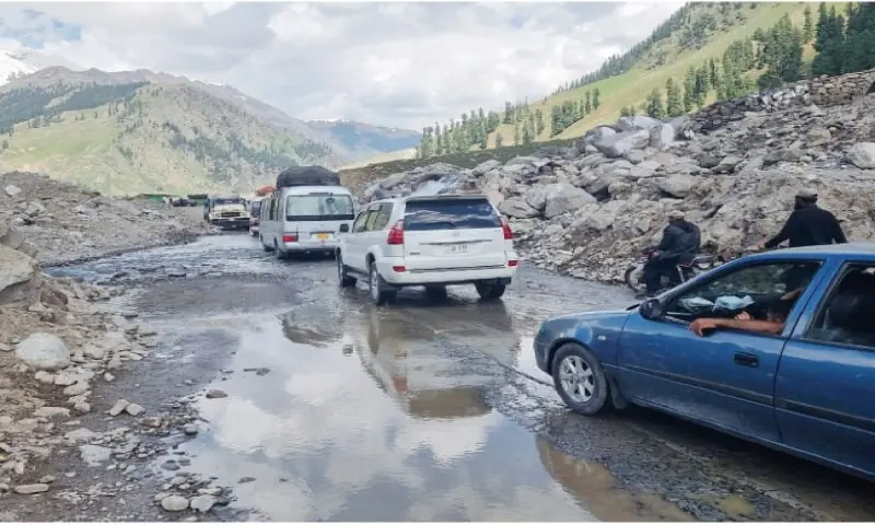 Undated image shows motorists driving through a dilapidated portion of MNJ Road. &mdash; Dawn