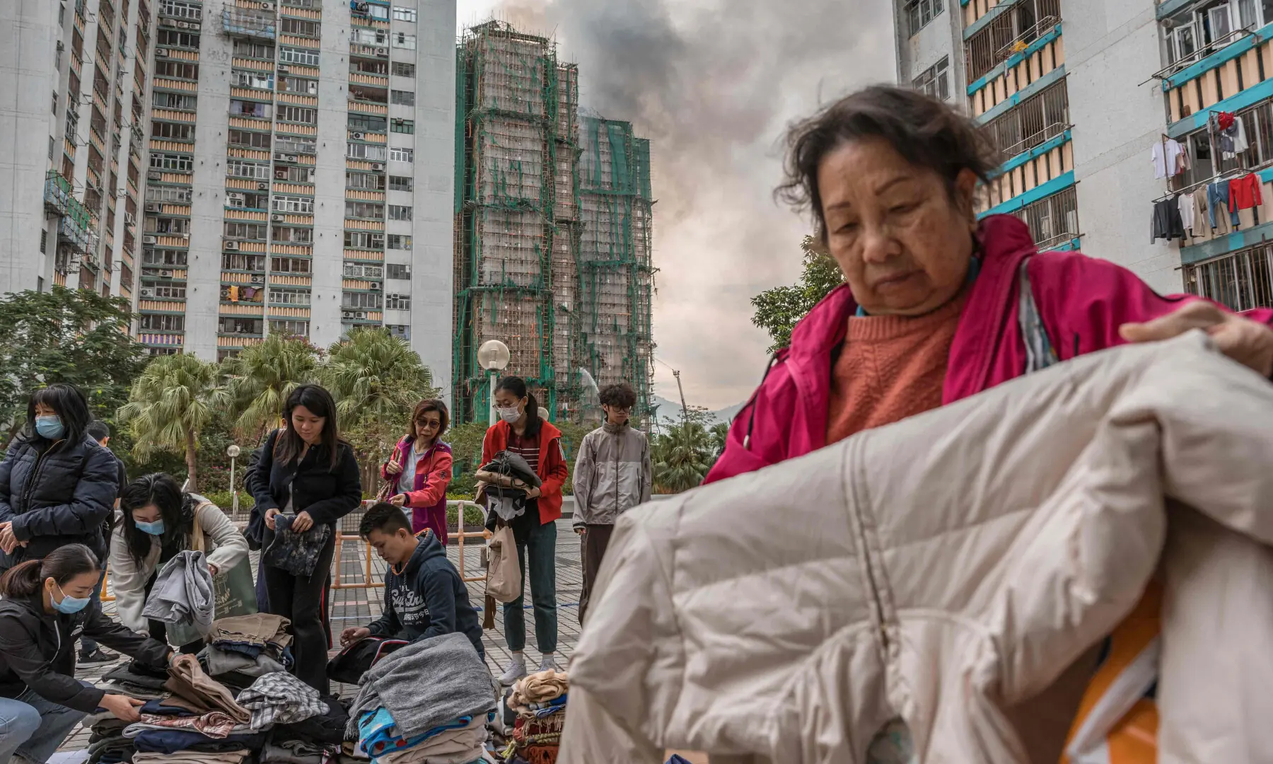 Residents sort through clothes donated to them after a major fire devastated several apartment blocks in the Wang Fuk Court housing estate in Hong Kong's Tai Po district on November 27, 2025. — AFP