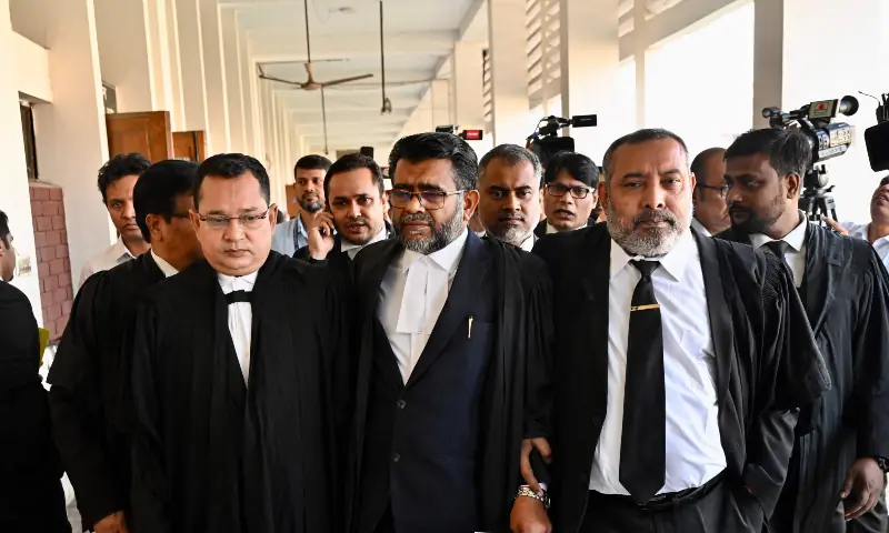 Public prosecutor Khan Moinul Hasan (C) leaves a court in Dhaka on November 27, 2025. Public prosecutor Khan Moinul Hasan (C) leaves a court in Dhaka on November 27, 2025.