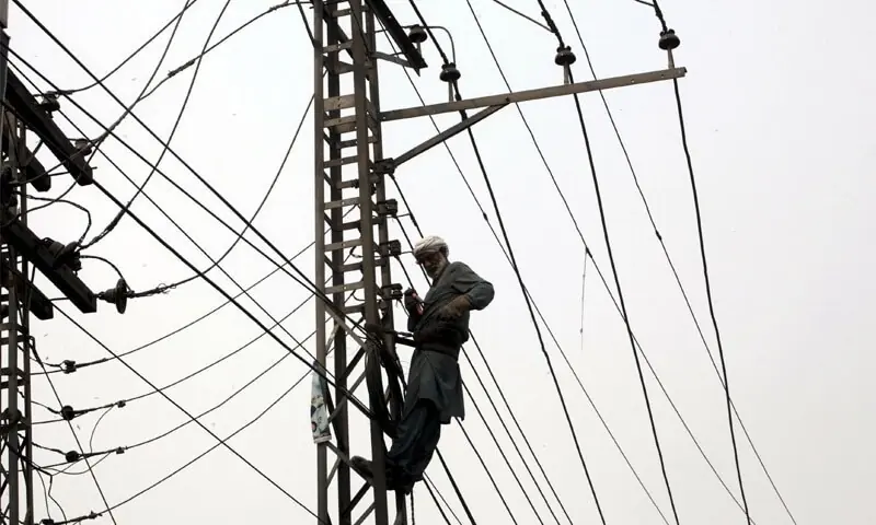 A file photo of an electrician working on power cables. &mdash; AFP/File