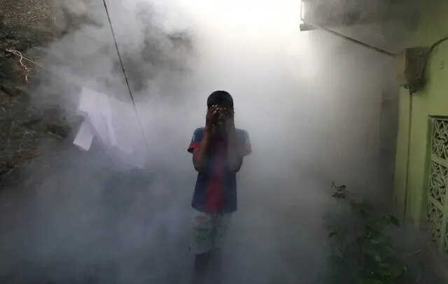 A boy covers his face from smoke as a health worker fumigates against mosquitoes in this file photo from July 21, 2023. —Reuters A boy covers his face from smoke as a health worker fumigates against mosquitoes in this file photo from July 21, 2023. —Reuters
