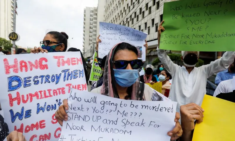 People carry signs against the killing of Noor Mukadam, 27, daughter of former Pakistani diplomat, and to condemn the violence against women and girls during a protest in Karachi on July 25, 2021. &mdash; Reuters/File