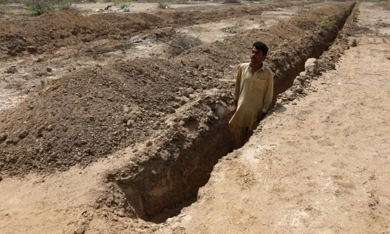 Shahid Balouch, a gravedigger, poses for a photograph in a mass grave in the cemetary, as preparations are made in case of another heatwave in Karachi, on May 13, 2016. — Reuters/File Shahid Balouch, a gravedigger, poses for a photograph in a mass grave in the cemetary, as preparations are made in case of another heatwave in Karachi, on May 13, 2016. — Reuters/File