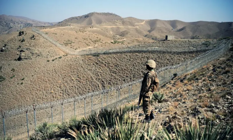 A Pakistani soldier keeps vigil next to a border fencing along Afghan border at Kitton Orchard Post in North Waziristan tribal agency on October 18, 2017. &mdash; AFP/File