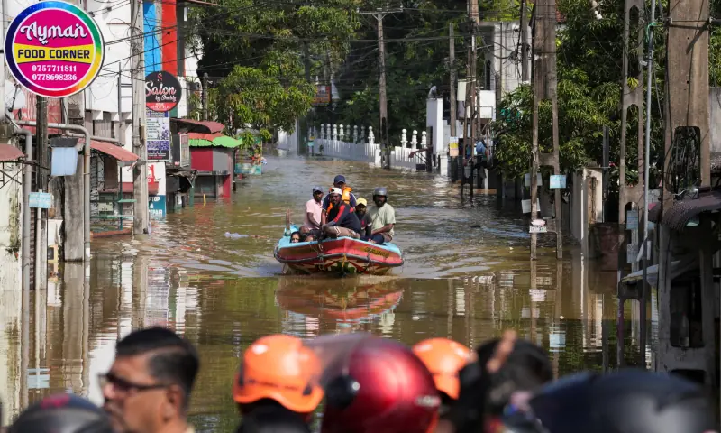 A boat carrying people moves through a flooded street, following heavy rainfall in Wellampitiya, Sri Lanka, on Nov 30, 2025. &mdash; Reuters