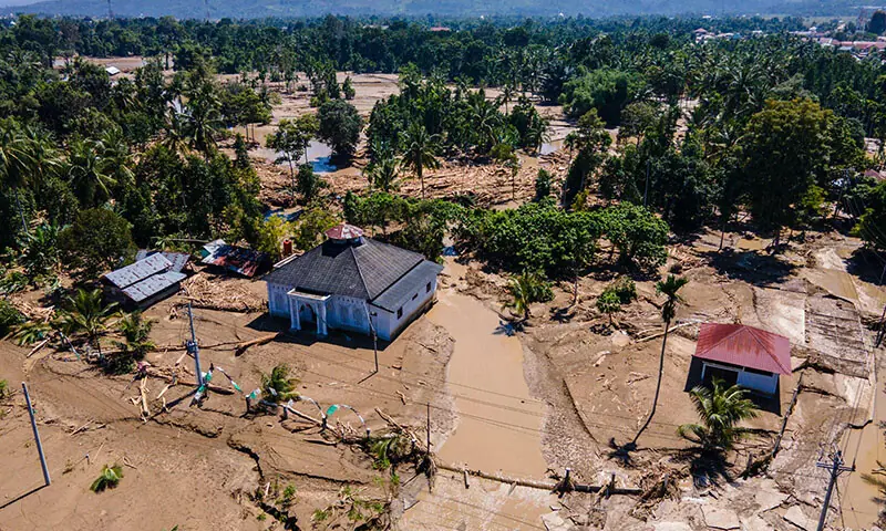 This aerial picture shows a mosque standing amid mud in a flood affected area amid flash floods in Meureudu, Pidie Jaya district in Indonesia’s Aceh province on November 30,. — AFP
