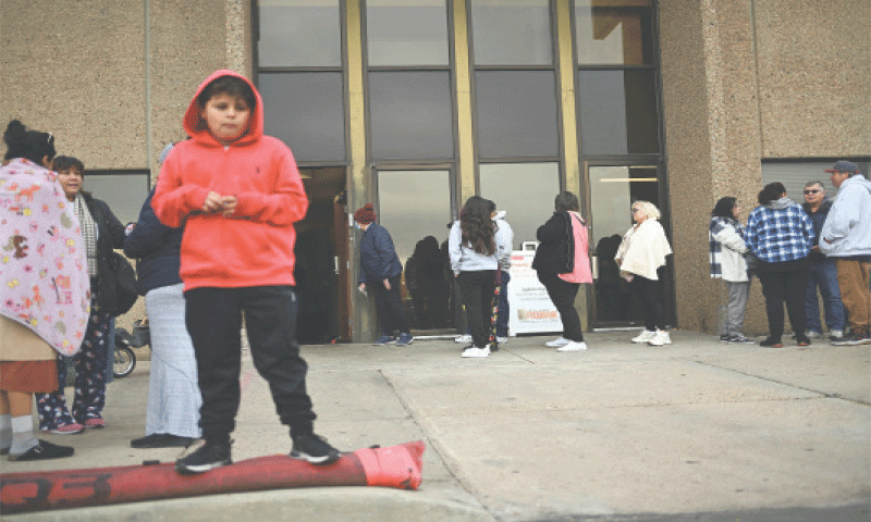 Commerce City (Colorado): People wait in line outside an emergency food bank on Friday.—Reuters Commerce City (Colorado): People wait in line outside an emergency food bank on Friday.—Reuters