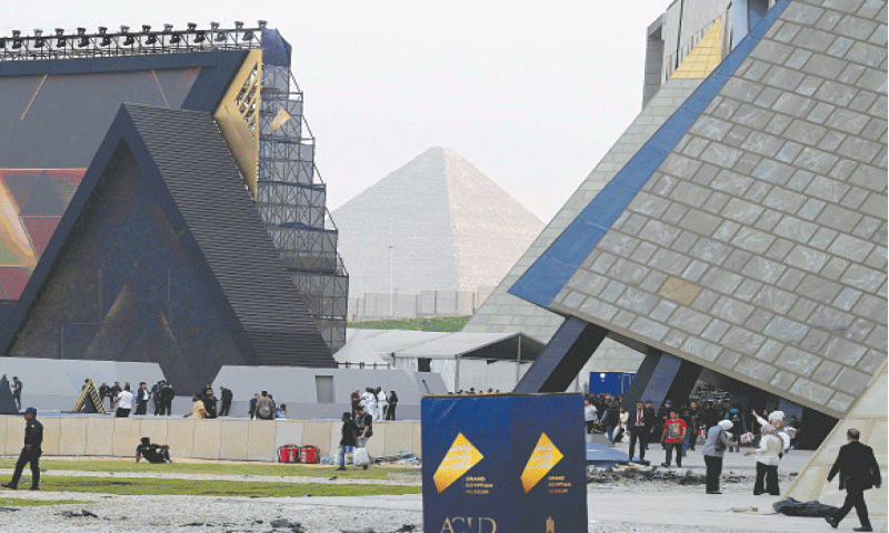 PEOPLE walk in the grounds of the Grand Egyptian Museum prior to its opening in Giza, on the southwestern outskirts of Cairo.—AFP PEOPLE walk in the grounds of the Grand Egyptian Museum prior to its opening in Giza, on the southwestern outskirts of Cairo.—AFP