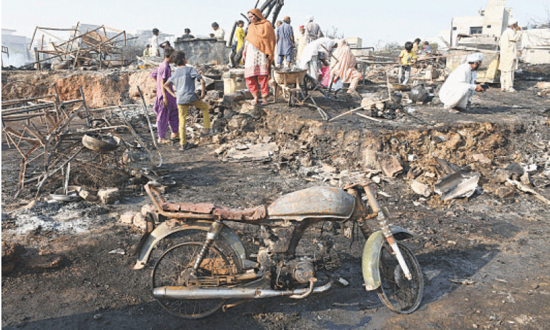 People look for salvageable belongings after a fire in an informal settlement in Gulistan-i-Jauhar.&mdash;Online