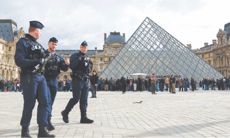 An Oct 27 file photo shows police officers walk near the glass Pyramid of the Louvre Museum after law enforcement agencies arrested suspects in the heist case.—Reuters An Oct 27 file photo shows police officers walk near the glass Pyramid of the Louvre Museum after law enforcement agencies arrested suspects in the heist case.—Reuters