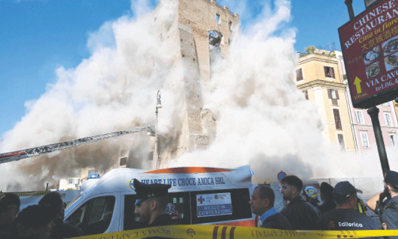 DUST rises after a part of the medaieval tower collapsed.&mdash;AFP
