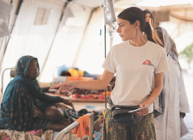 TAWILA (Sudan): A member of Doctors Without Borders (MSF) counts injured and displaced Sudanese who fled violence in Al Fasher and are receiving treatment at a makeshift clinic.—Reuters