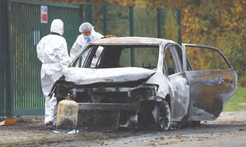 FRENCH gendarmes inspect the burnt car used by a driver who rammed into pedestrians and cyclists on the touristic French island of Ile d’Oleron.—Reuters FRENCH gendarmes inspect the burnt car used by a driver who rammed into pedestrians and cyclists on the touristic French island of Ile d’Oleron.—Reuters