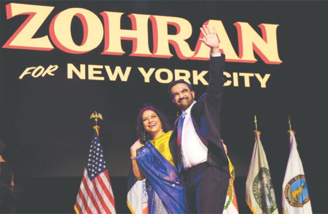flanked by his mother, Indian filmmaker Mira Nair, Zohran Mamdani waves from the stage after winning the 2025 New York mayoral race.—Reuters